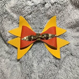 Hand crafted yellow, orange and gold hair clip bow.